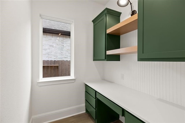 home office with dark hardwood / wood-style flooring