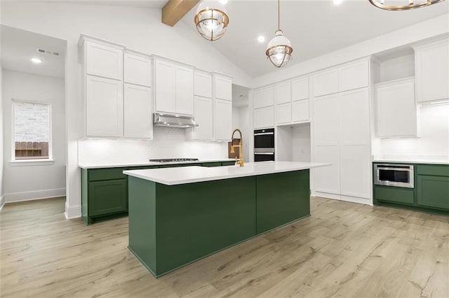 kitchen with double oven, hanging light fixtures, light hardwood / wood-style floors, white cabinets, and decorative backsplash