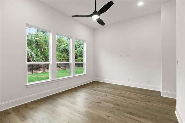 unfurnished room featuring dark wood-type flooring and ceiling fan