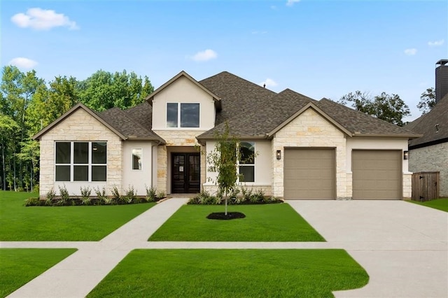 view of front of home featuring a garage, a front yard, and french doors