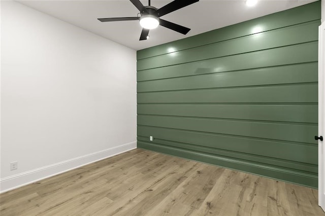 spare room featuring ceiling fan and light hardwood / wood-style flooring