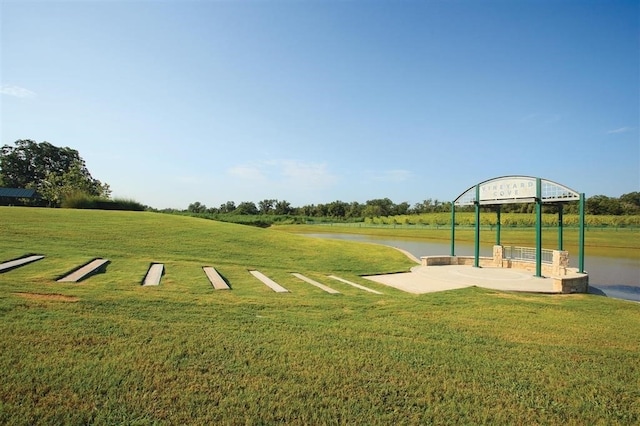 view of property's community featuring a water view and a yard