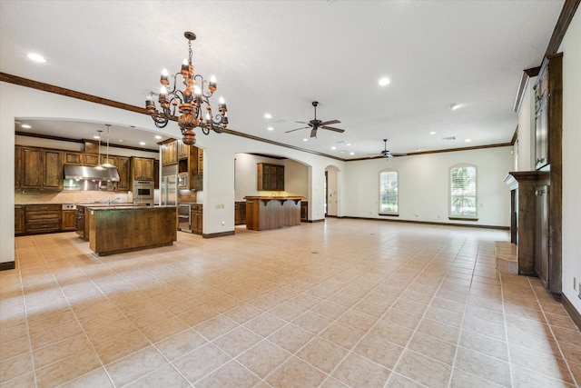 interior space with pendant lighting, stainless steel oven, an island with sink, and light tile patterned floors