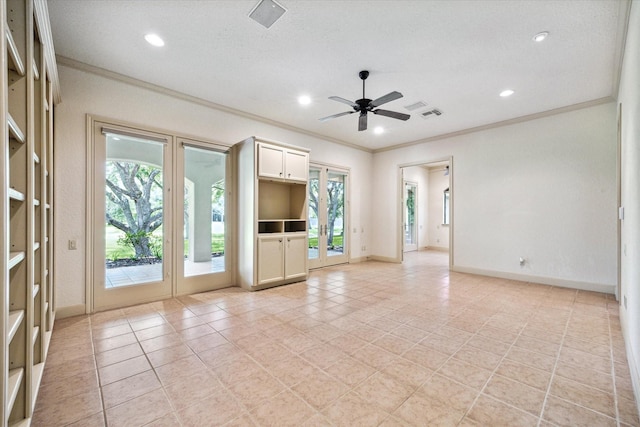 unfurnished living room featuring ornamental molding, ceiling fan, and french doors