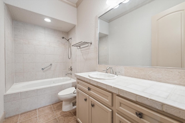 full bathroom with tiled shower / bath combo, vanity, ornamental molding, toilet, and tile patterned floors