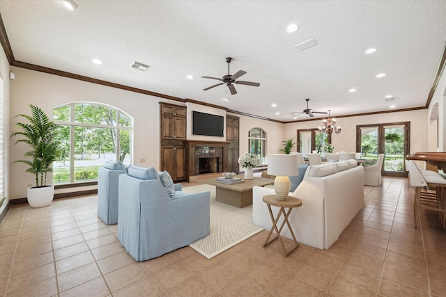 living room featuring crown molding, a fireplace, a textured ceiling, and light tile patterned floors