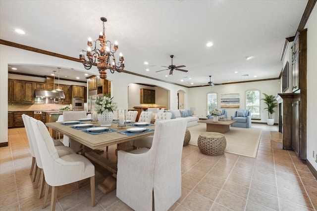 tiled dining space with ornamental molding and ceiling fan with notable chandelier