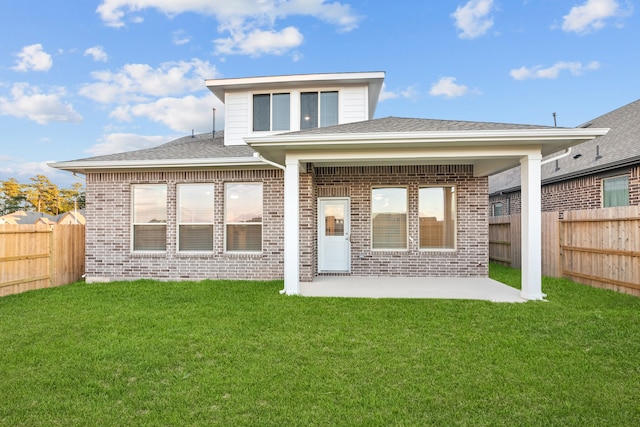 back of property featuring a yard and a patio