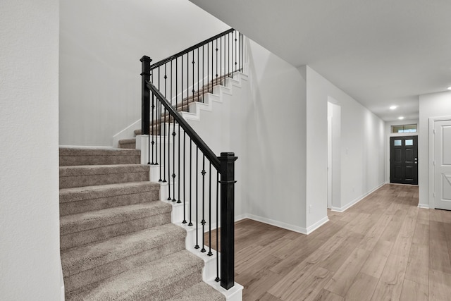 stairs with hardwood / wood-style floors