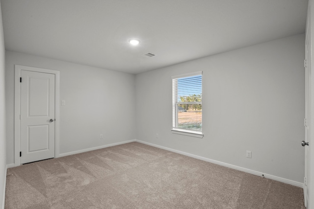 unfurnished room with light colored carpet