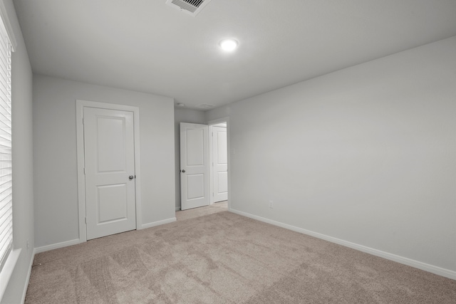 unfurnished bedroom with light carpet