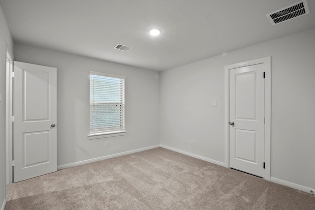 spare room with light carpet