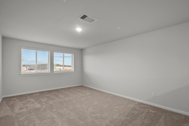 empty room featuring light colored carpet