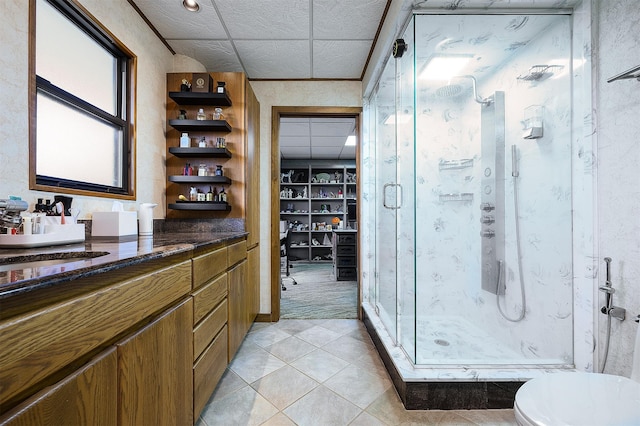 bathroom with toilet, tile patterned flooring, vanity, and walk in shower