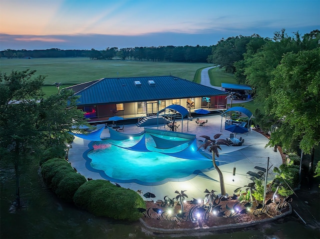 view of pool at dusk