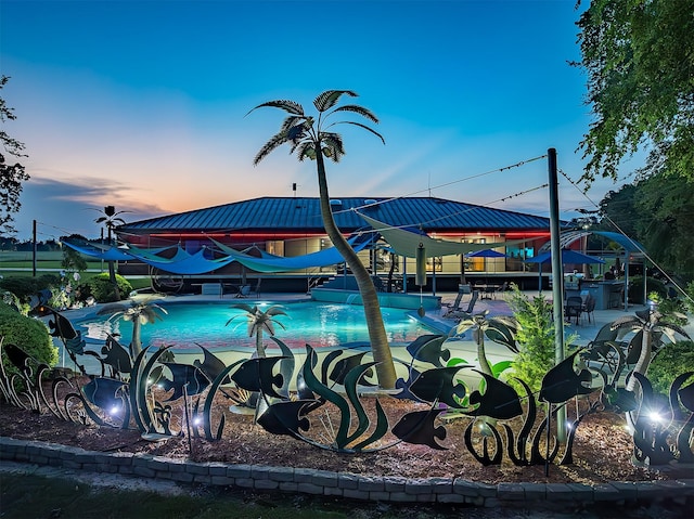 view of pool at dusk