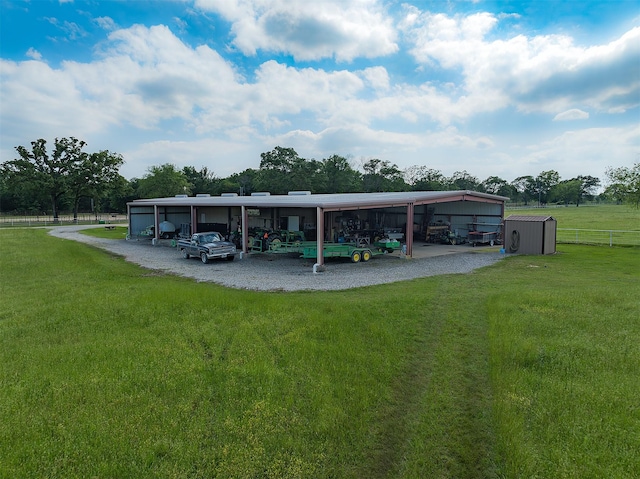 view of parking / parking lot featuring a carport and a yard