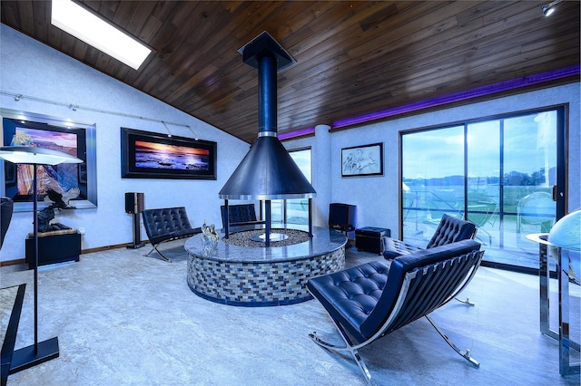 living room featuring a wood stove, vaulted ceiling with skylight, and wood ceiling