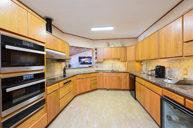 kitchen featuring black appliances, light wood-type flooring, backsplash, and beverage cooler