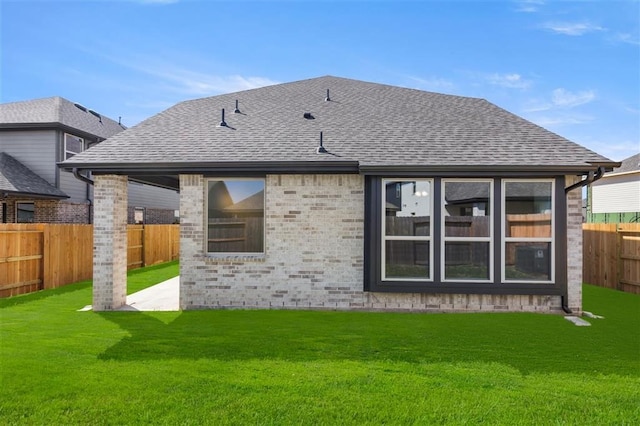 rear view of property featuring a patio area and a lawn