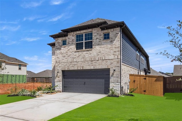 view of front of property featuring a garage and a front yard