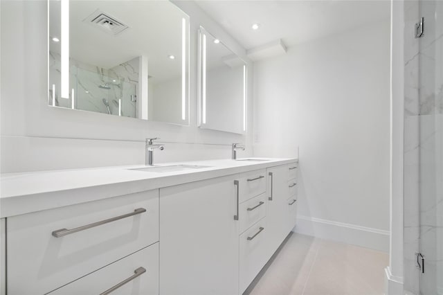 bathroom featuring tile patterned flooring, a shower with door, and vanity