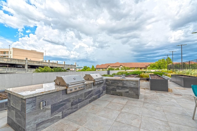 view of patio featuring a grill and an outdoor kitchen