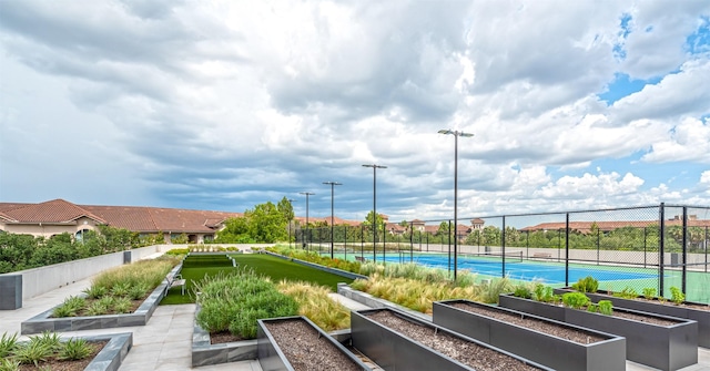 surrounding community featuring tennis court