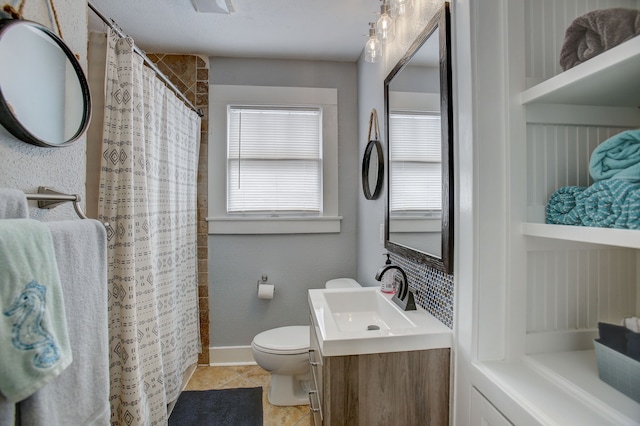 bathroom with vanity, toilet, walk in shower, and tile patterned flooring