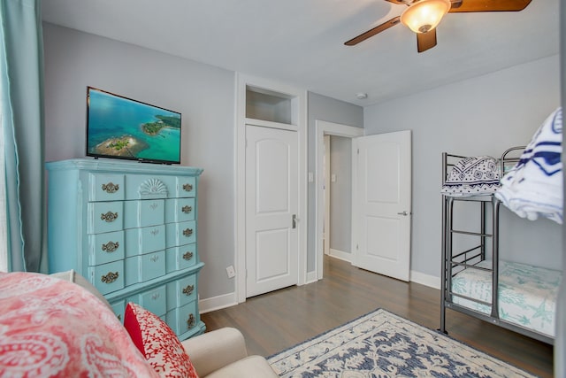 bedroom with ceiling fan and dark hardwood / wood-style flooring