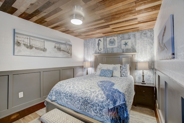 bedroom featuring light wood-type flooring and wooden ceiling