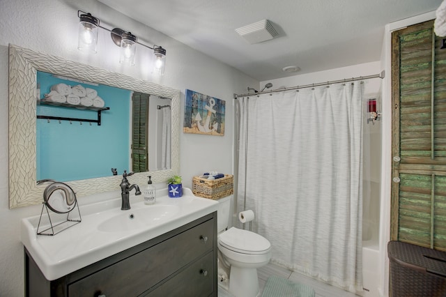 full bathroom with tile patterned flooring, toilet, shower / tub combo, and vanity