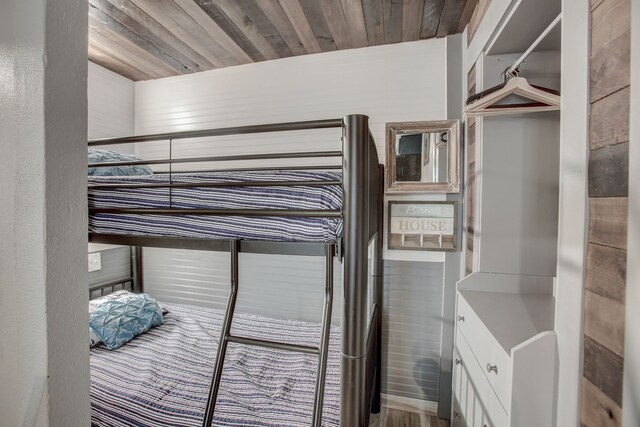 bedroom featuring wood ceiling and hardwood / wood-style flooring