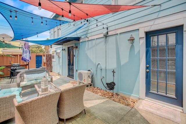 view of patio with ac unit, an outdoor hangout area, and a storage shed