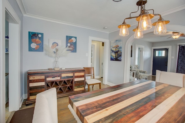 dining room featuring ornamental molding and dark hardwood / wood-style flooring