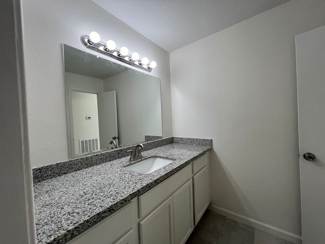 bathroom featuring tile floors and vanity