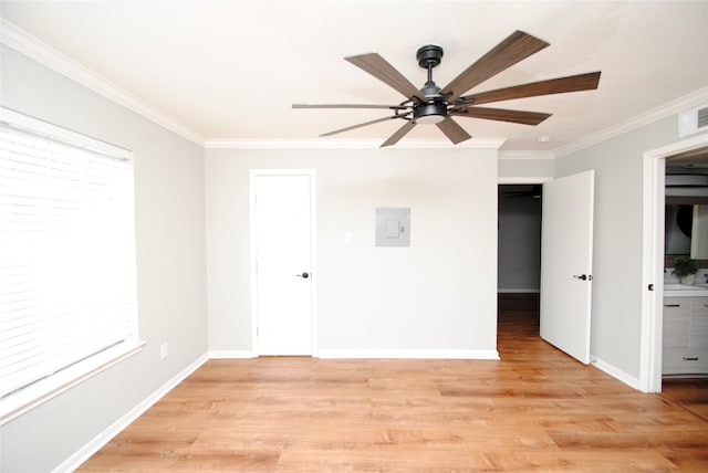 spare room with ceiling fan, light hardwood / wood-style floors, and crown molding