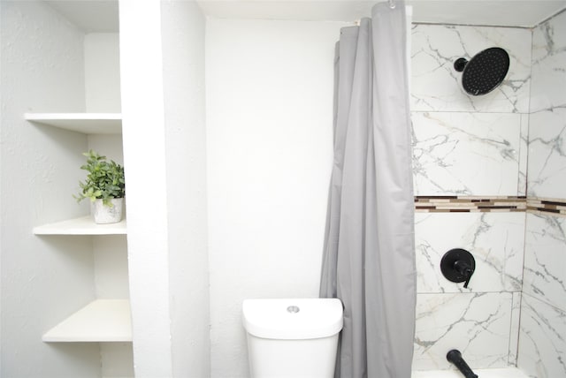 bathroom with curtained shower and toilet