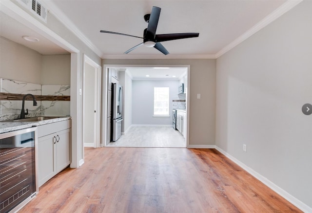 kitchen with ceiling fan, sink, light hardwood / wood-style flooring, and wine cooler