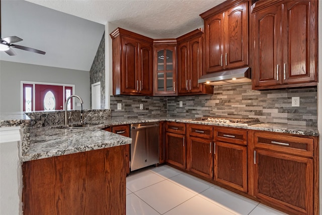 kitchen featuring appliances with stainless steel finishes, tasteful backsplash, kitchen peninsula, and sink