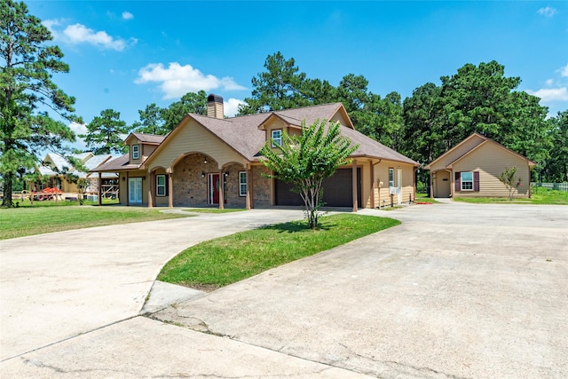 view of front of property featuring a front lawn and a garage