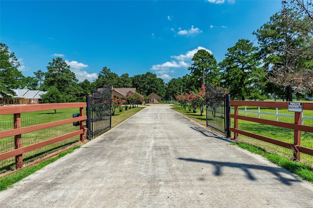 view of gate featuring a yard