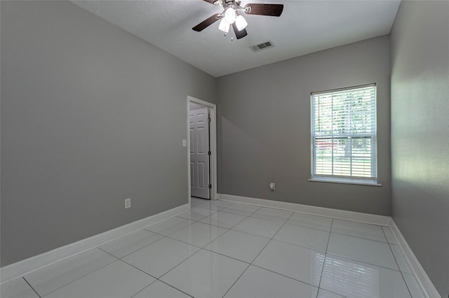 spare room featuring ceiling fan and light tile patterned flooring