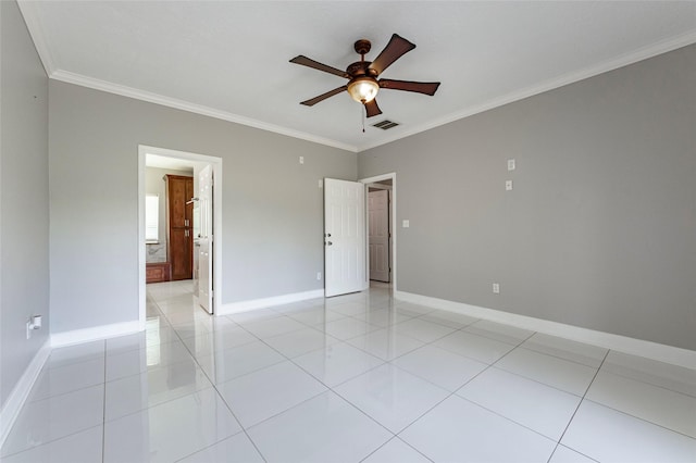 tiled spare room featuring ceiling fan and ornamental molding