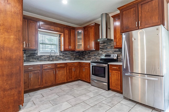 kitchen with wall chimney range hood, ornamental molding, tasteful backsplash, and appliances with stainless steel finishes