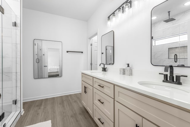 bathroom featuring hardwood / wood-style floors, vanity, and walk in shower