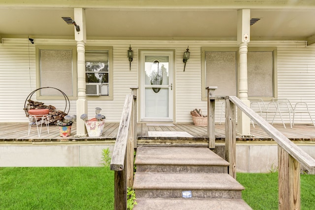 view of exterior entry with covered porch