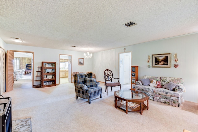 carpeted living room with a textured ceiling and an inviting chandelier