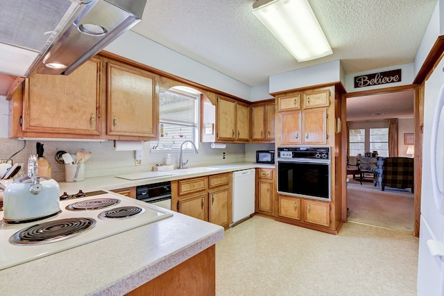 kitchen featuring a textured ceiling, white appliances, sink, and range hood