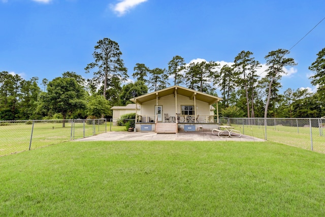 rear view of property featuring a yard and a patio